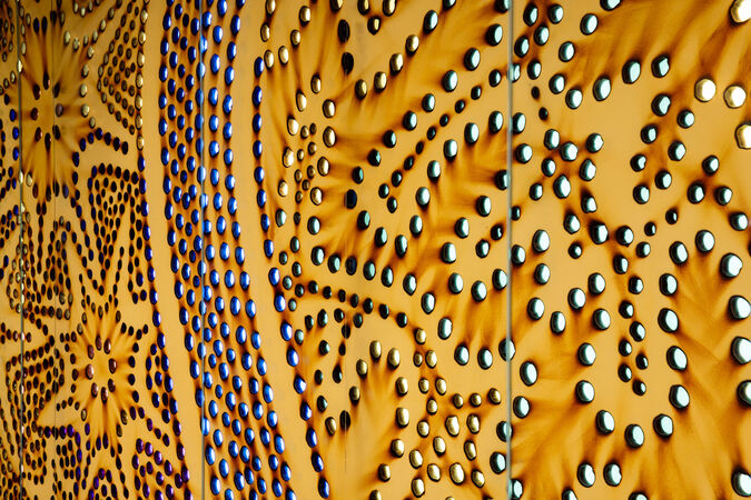Detailed close up of "Kurilpa Country" by Lilla Watson showing bright spots on burnt brown paper