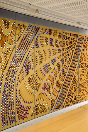 Half of a large artwork called "Kurilpa Country" by Lilla Watson showing bright spots on burnt brown paper