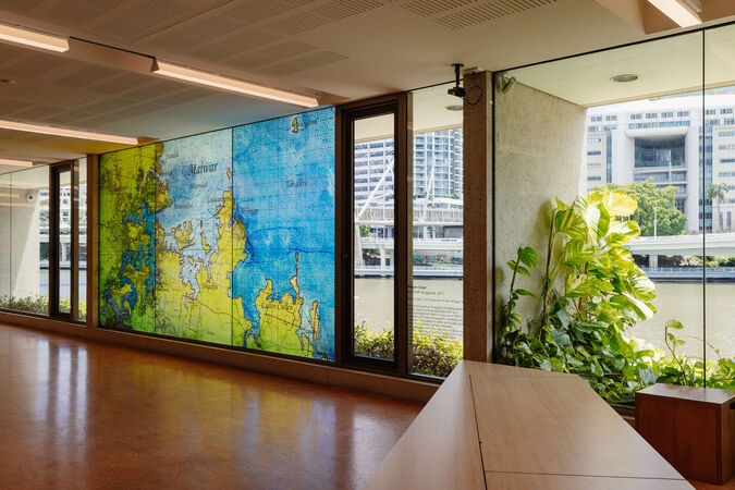 "MAIWAR Yunggulba" by Megan Cope in kuril dhagun; the art installation takes up a window with an image of a large map