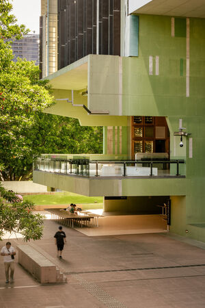 Queensland Terrace at State Library of Queensland; it is a large verandah in marble, green concrete, and timber cabinetry. People are walking on the ground below.