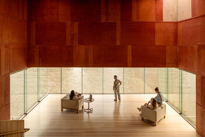 Red Box at State Library of Queensland; timber floors, people on couches, a wall of glass overlooking the river