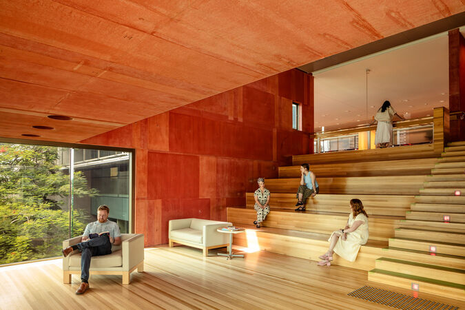 Red Box at State Library of Queensland; timber floors, and people on couches and the stairs 