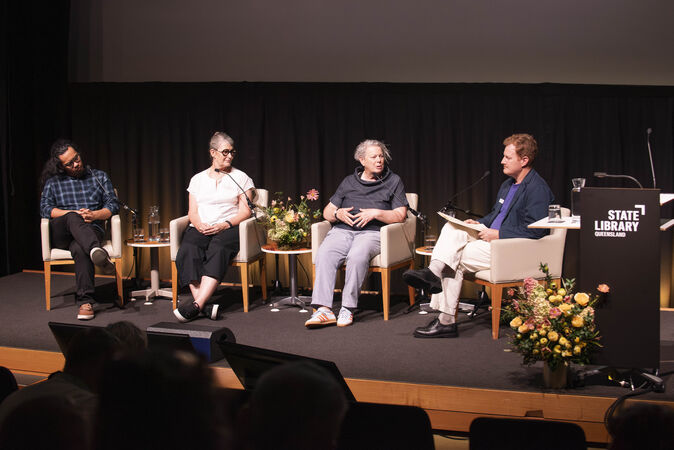 Four panelists and a host on stage
