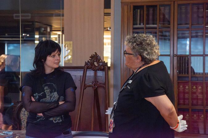 A librarian talks with a Research Reveals attendee 