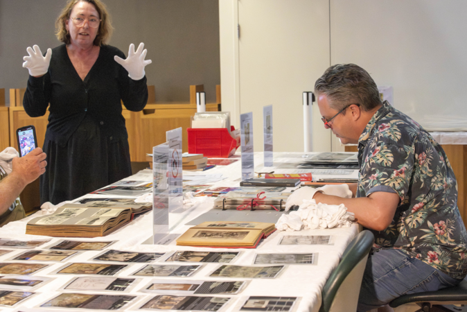 Attendees browsing historical collections on a table