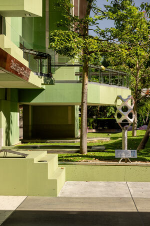 Front entrance of State Library of Queensland showing green balconies and seats and the 'Paradigm' maquette by Jon Barlow Hudson