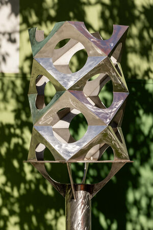 A stainless steel sculpture in a garden – 'Paradigm' maquette by Jon Barlow Hudson