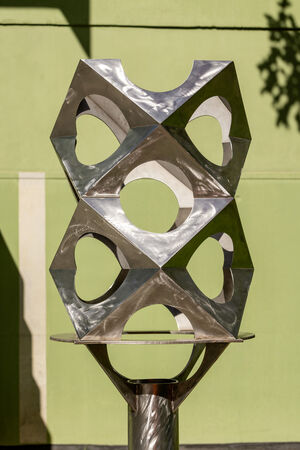 A stainless steel sculpture in a garden – 'Paradigm' maquette by Jon Barlow Hudson