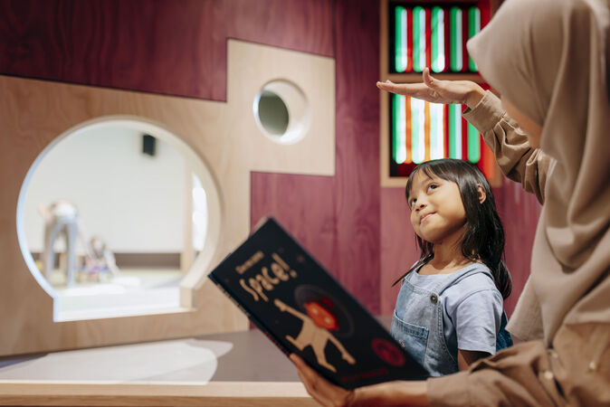 Mother and child reading a picture book.