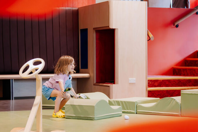 Child playing with large soft blocks.