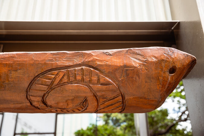 Close up detail of a wooden coolamon by Laurie Nilsen that hangs in the Talking Circle
