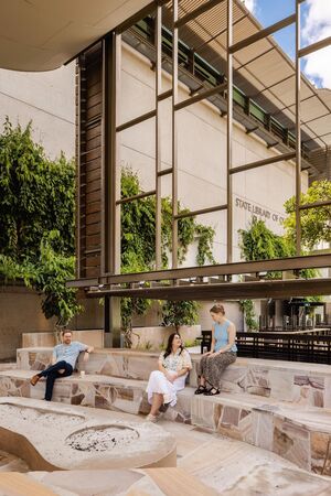 People seated around the fire pit, relaxing in the kuril dhagun Talking Circle.