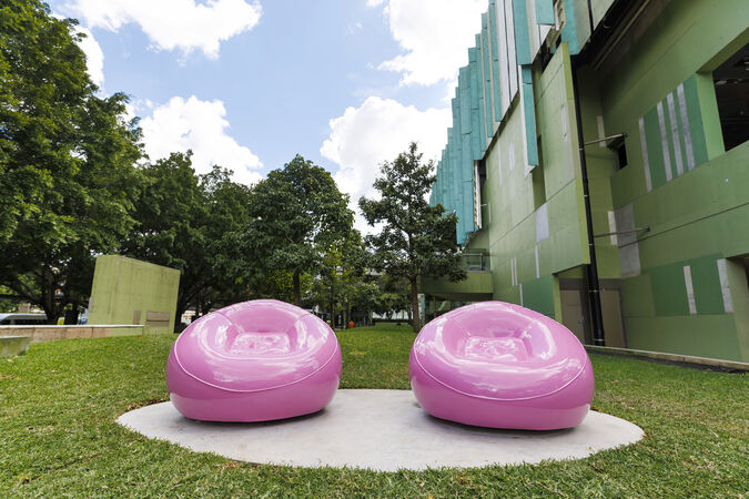 The artwork 'Pink Chairs' by Cj Hendry on the lawn out the front of State Library of Queensland
