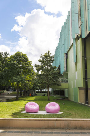 The artwork 'Pink Chairs' by Cj Hendry on the lawn out the front of State Library of Queensland