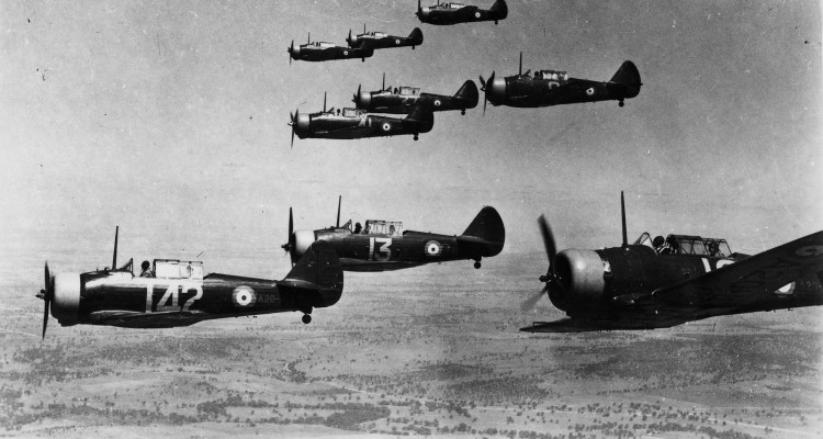 Old photograph of 9 aircraft flying.