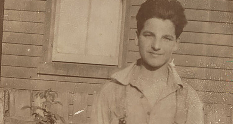 Informal portrait of Yvon Calmus, a young French war refugee 'souvenired' by members of the 2nd Field Artillery Brigade (2nd FAB) and brought back to Australia to live.