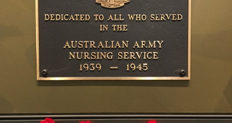 Memorial plaque dedicated to the Australian Army Nursing Service with poppies added below.