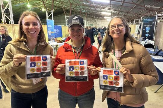 3 ladies holding up Digital and You merchandise