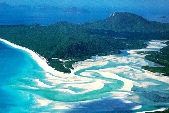Aerial photographs of a light blue inlet on Whitsunday Island 