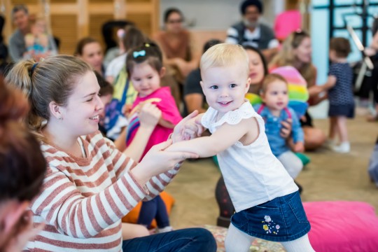 Woman and child dancing at Toddler time