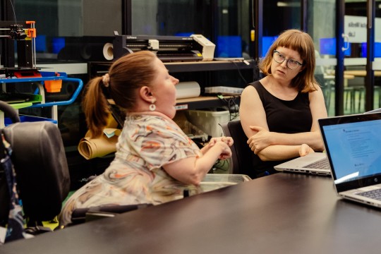 two young women converse
