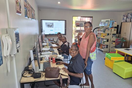 Community members working on computers during a digital workshop at Wujal Wujal IKC