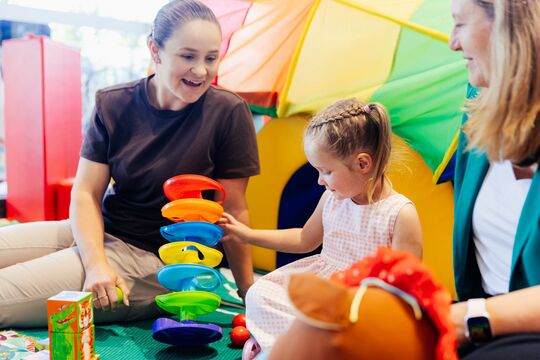 Ash Barty playing with building blocks with girl and mother