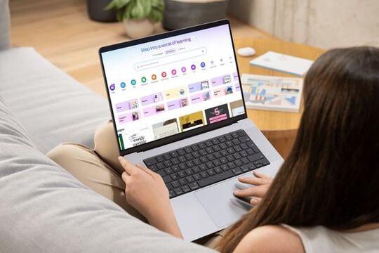 Lady using Canva design program on a laptop