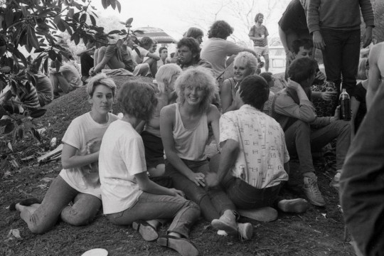 People attending 4ZZZ market day, 1982, relaxing on a hill.