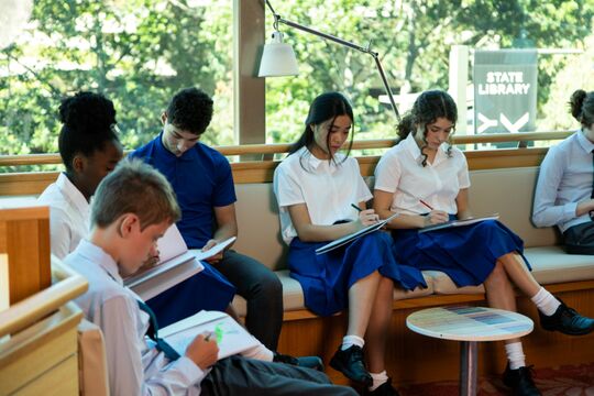 A group of students studying on level 3 of State Library of Queensland