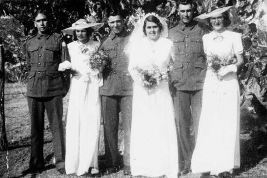 Wedding photo of three First Nations couples with the men all in service uniforms