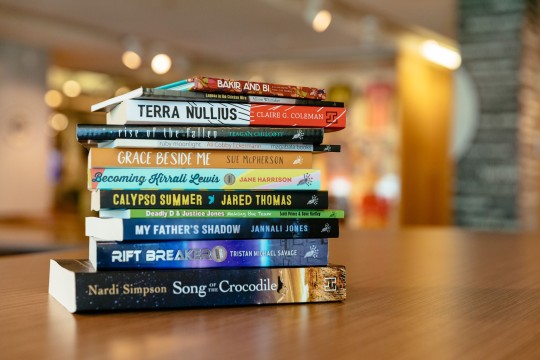 A stack of books by black&write! authors taken in State Library