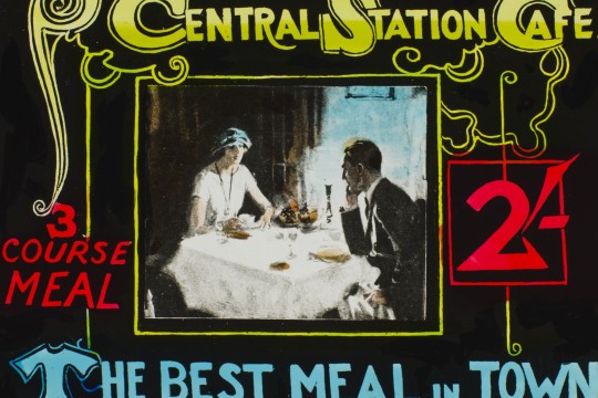 Colourful graphic advertisement showing 2 people enjoying a meal at railway cafe 