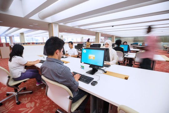 People using computers at the State Library of Queensland. 