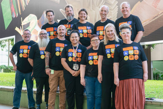 Group of people wearing 'Digital and you' branded t-shirts.