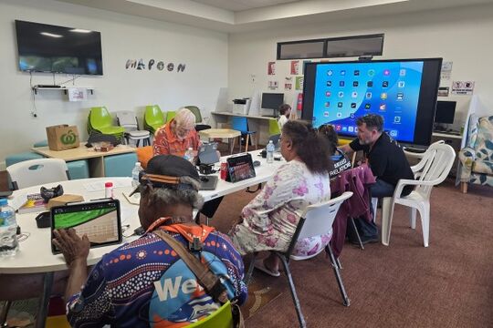 People working on tablet computers in a workshop