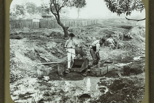 Gold miners using gold washing cradles while mining for gold in Queensland, ca, 1890