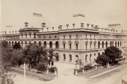 Corner view of historic building with dome roofs and window arches 1894