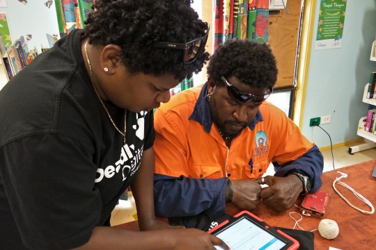 Indigenous Knowledge Centre Coordinator showing a community member who to use an iPad