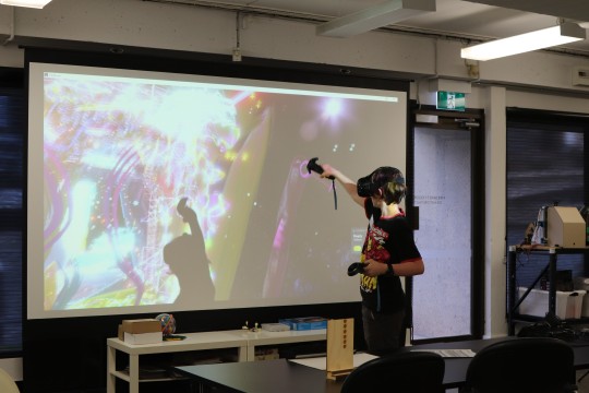 Young person painting with a VR headset on