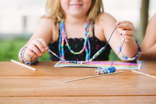 A child participating in Jemima Wyman’s Paisley beads  activity, 2014 / Photograph: Katie Bennett. 