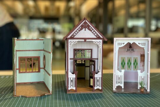A row of queensland in miniature book nooks.