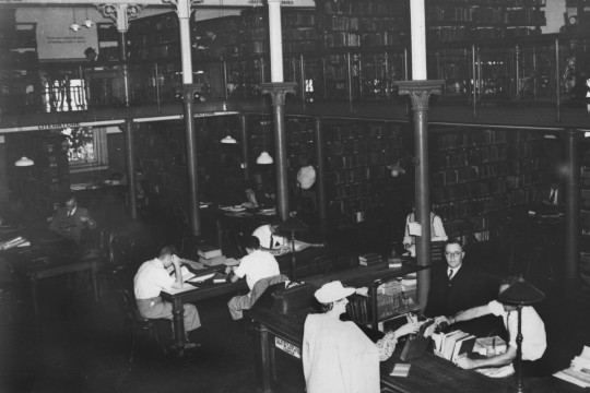 People sitting at tables in State Library of Queensland 1945