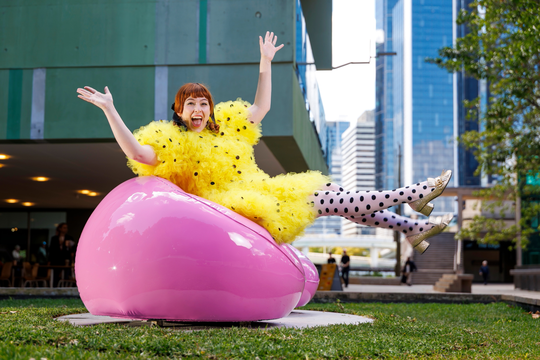 woman sitting on Cj Hendry's ‘Inflated’ pink chairs