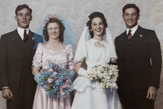 1940s wedding party in studio with groomsman, bridesmaid, bride and groom