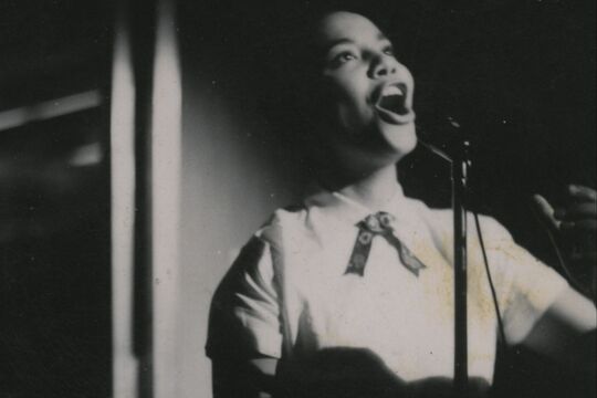 Singer performing on stage with a microphone