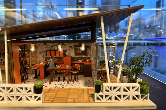 A close up shot of a Mid Century in Miniature Model. The model is showing the layout of kitchen and outdoor patio space. 