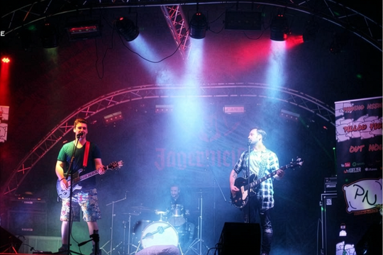 Musician Rory Price performing on stage.