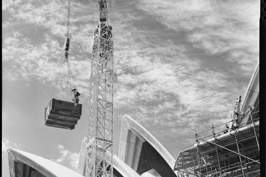 Crane hoisting materials for building the Sydney Opera House