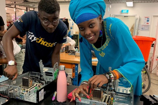 A man and a woman participating in the 2019 Siganto Digital Learning Workshops, rebuilding a computer.
